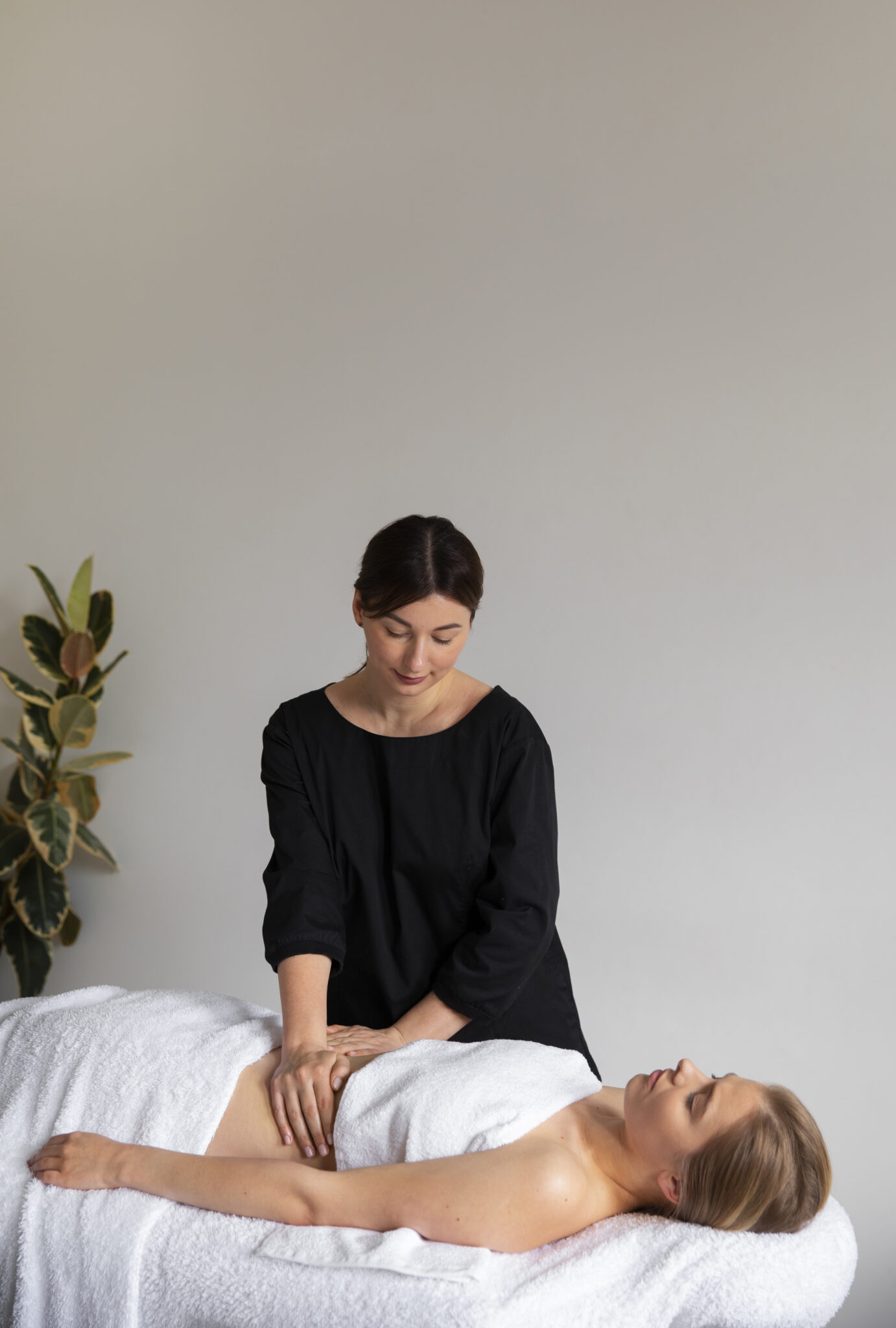 female masseur giving back massage client